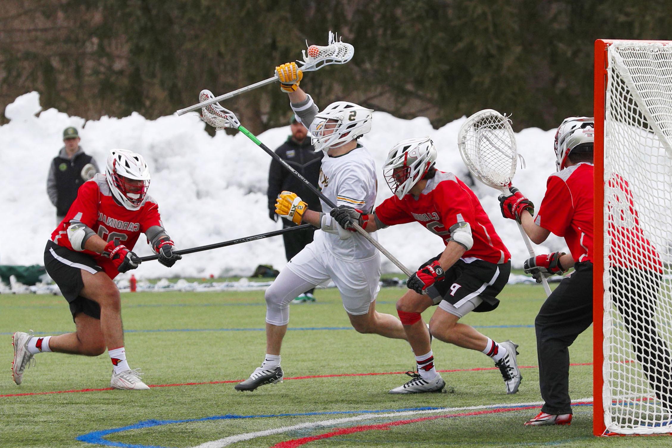 a scene of multiple men's lacrosse players in action during a game
